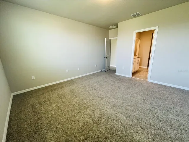 an empty room with closet and a window