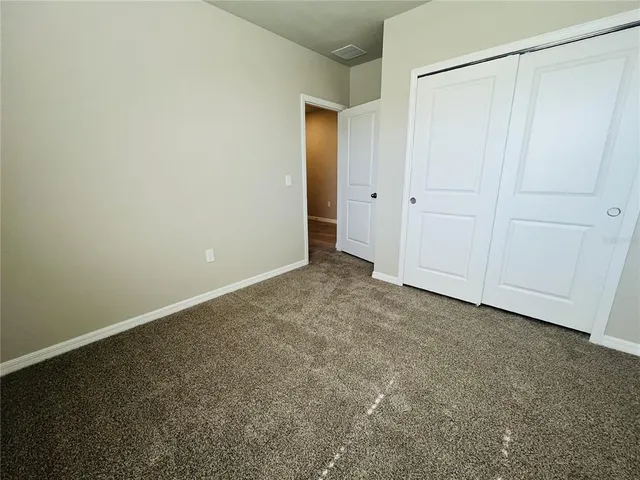 an empty room with closet area