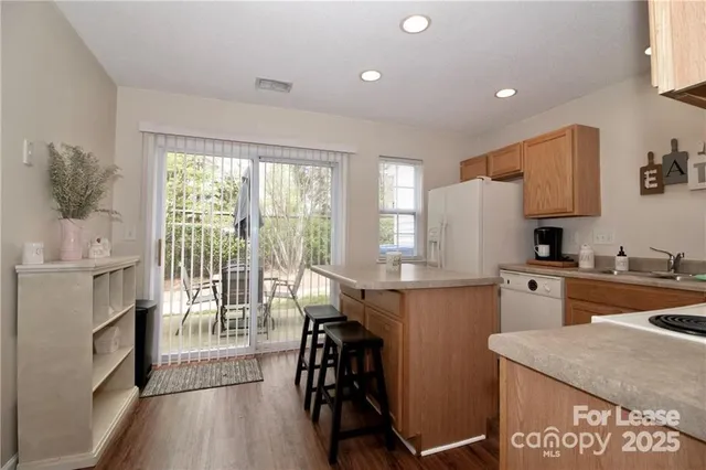 a kitchen with a table chairs stove and cabinets