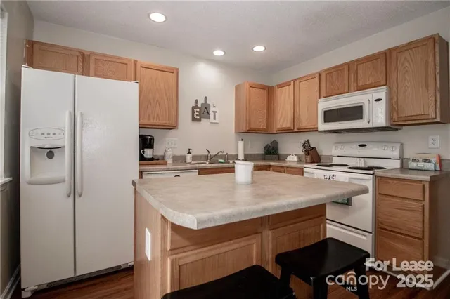 a kitchen with a refrigerator and a sink