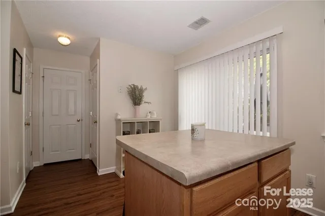 a kitchen with a table and chairs