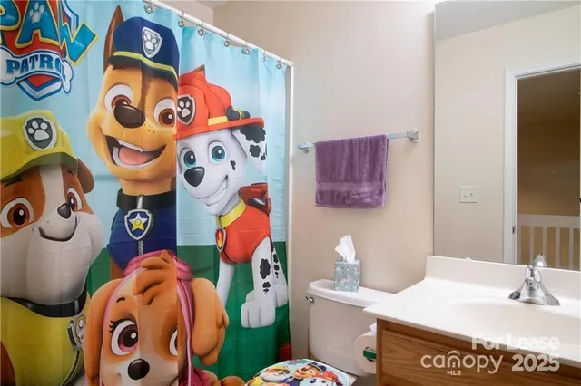 a bath room with a couch and a toilet