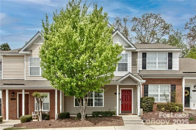 front view of a house with a tree