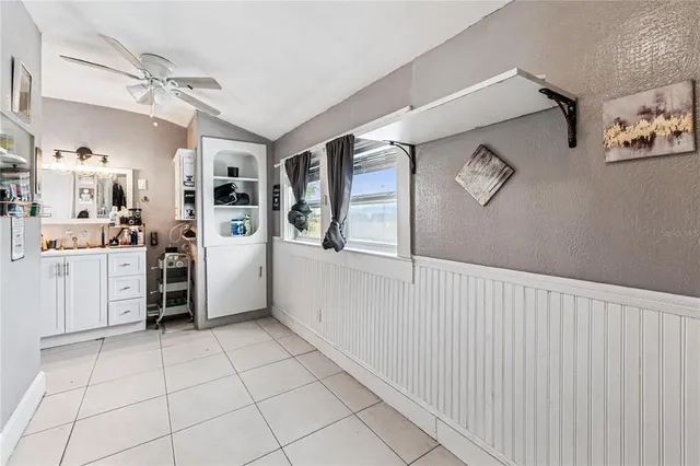a spacious bathroom with a shower sink and mirror