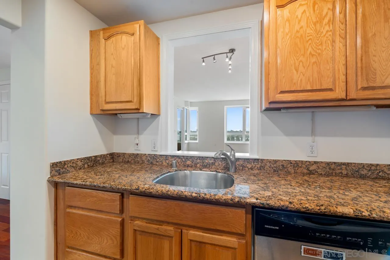 3890 Nobel, Unit 1205 San Diego, CA 92122 - Photo 3 of 19 a kitchen with granite countertop white cabinets and a sink