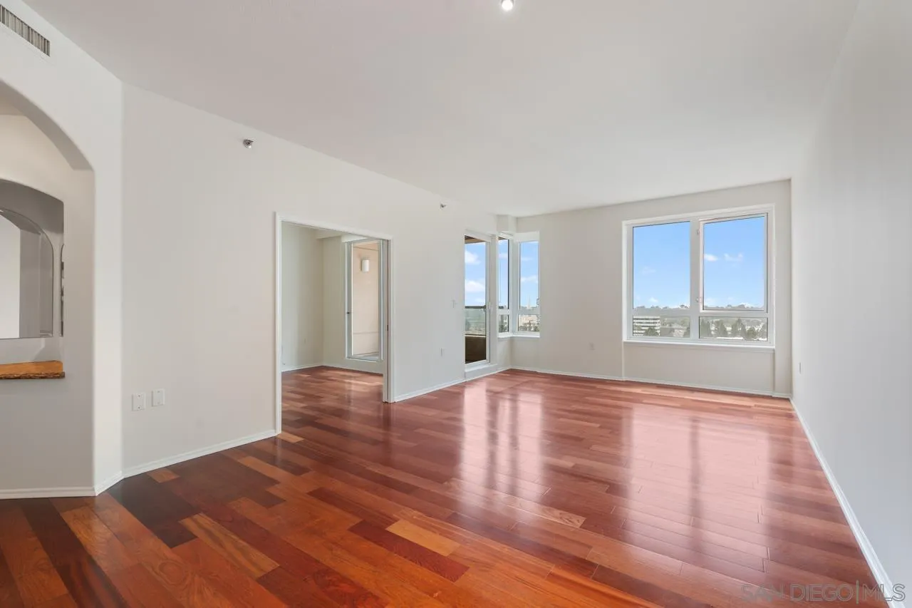 3890 Nobel, Unit 1205 San Diego, CA 92122 - Photo 4 of 19 a view of an empty room with wooden floor and a window
