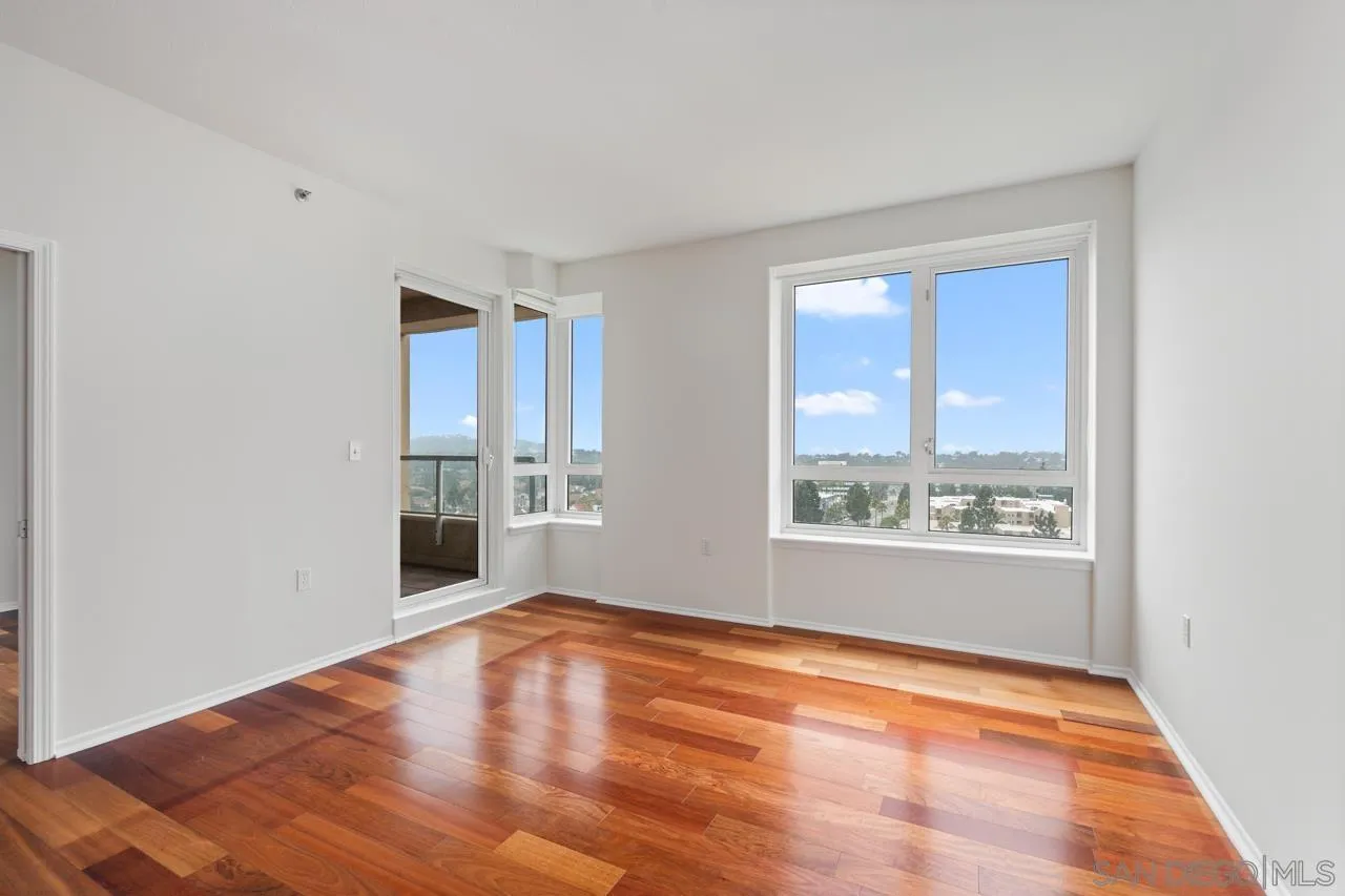 3890 Nobel, Unit 1205 San Diego, CA 92122 - Photo 5 of 19 a view of empty room with wooden floor and fan