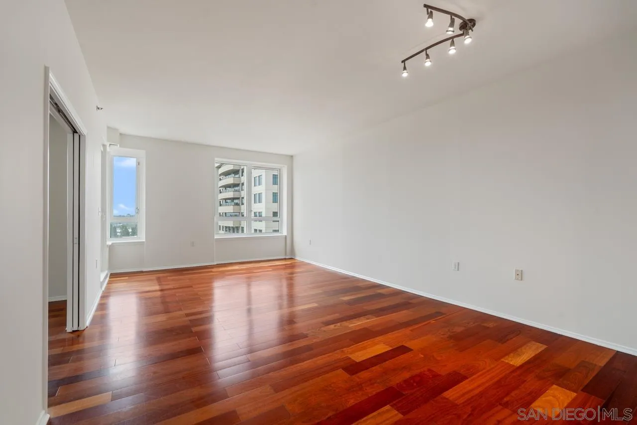 3890 Nobel, Unit 1205 San Diego, CA 92122 - Photo 6 of 19 a view of an empty room with wooden floor and a window