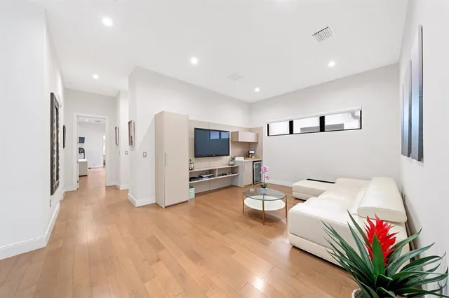 a large bathroom with a double vanity sink toilet mirror and shower