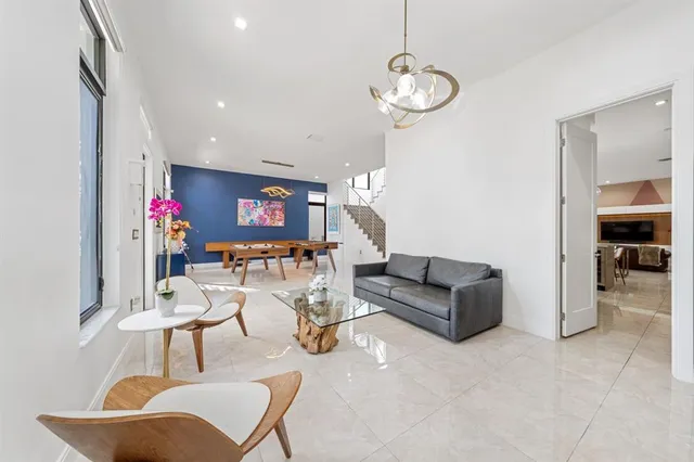 a large kitchen with stainless steel appliances granite countertop a sink a stove and a wooden floors