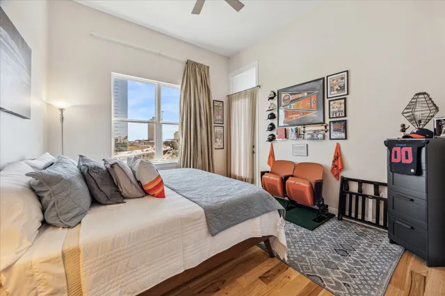 a bedroom with a bed and wooden floor
