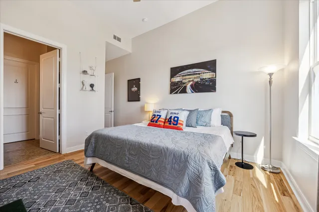 a bedroom with a bed and a rug