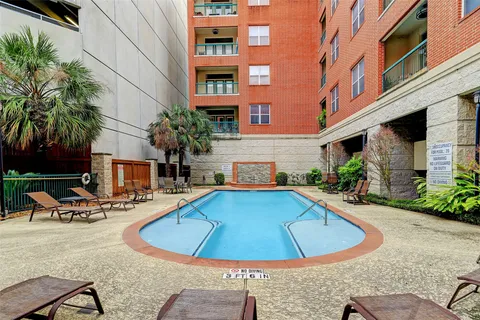 a view of a swimming pool with a lounge chairs