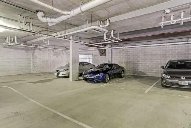 a view of parking garage with cars