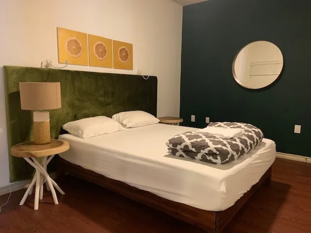 a bedroom with a bed and a lamp on table