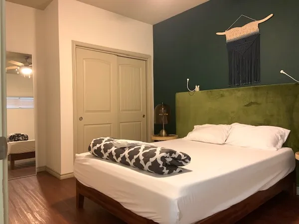 a bedroom with a bed and a chandelier