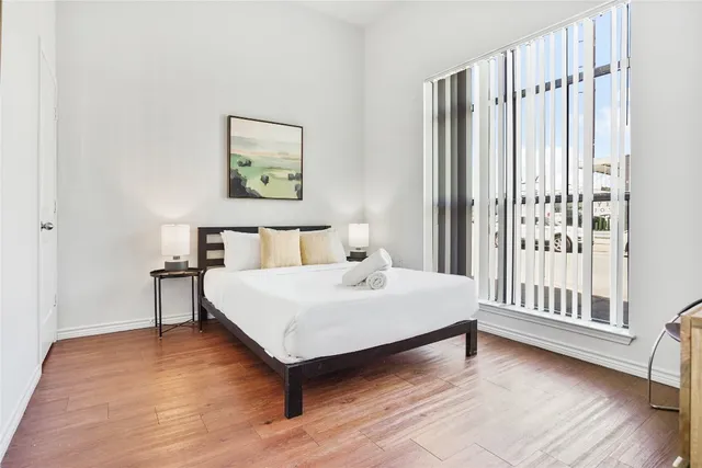 a bedroom with a bed and a window