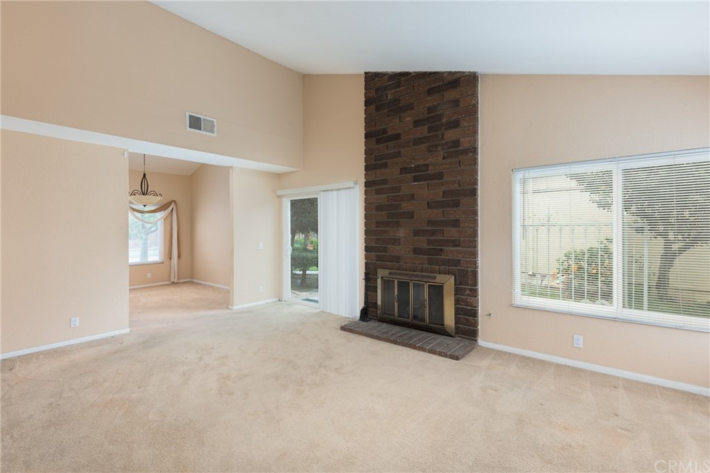61 Sparrowhawk Irvine, CA 92604 - Photo 13 of 29 a view of an empty room with a fireplace and a window