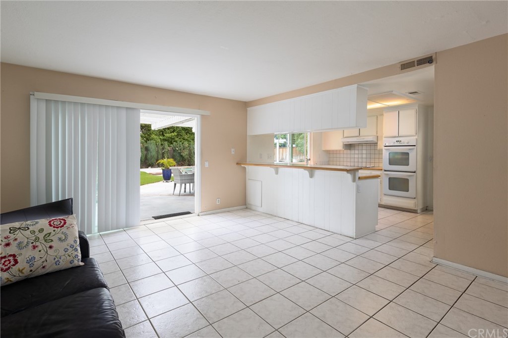 61 Sparrowhawk Irvine, CA 92604 - Photo 17 of 29 a view of a kitchen with microwave and cabinets