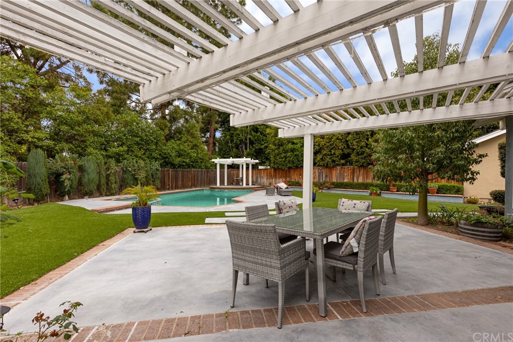 61 Sparrowhawk Irvine, CA 92604 - Photo 7 of 29 a view of a patio with a table chairs and a backyard