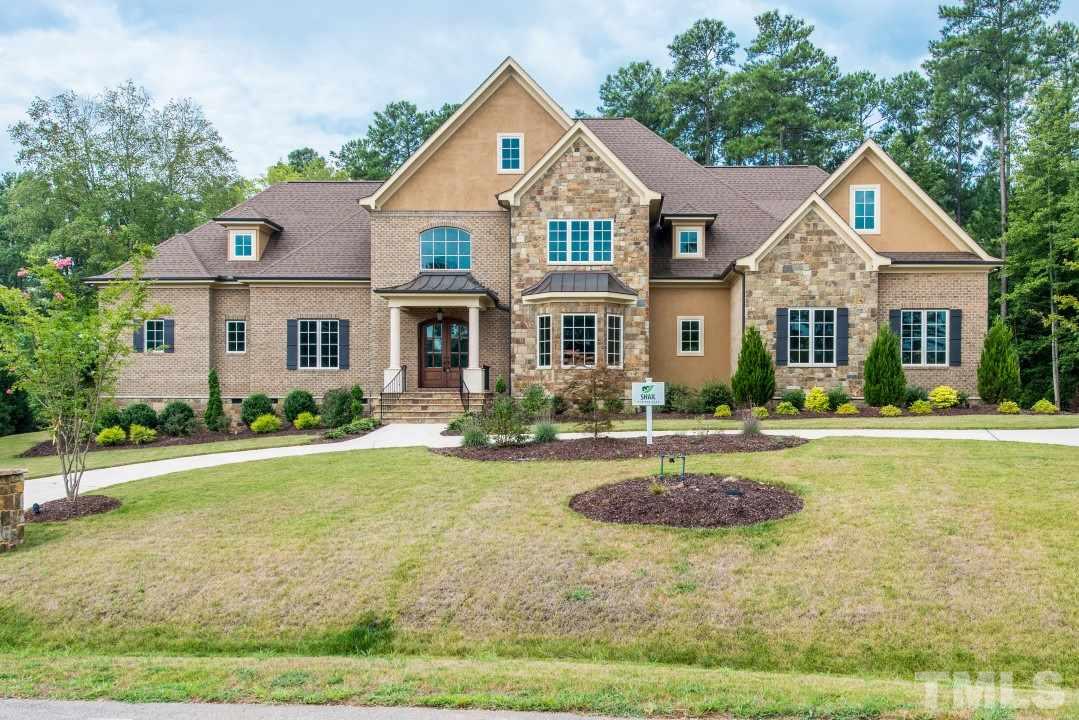11005 Soco Gap Court Raleigh, NC 27613 - Photo 1 of 25 a front view of a house with garden