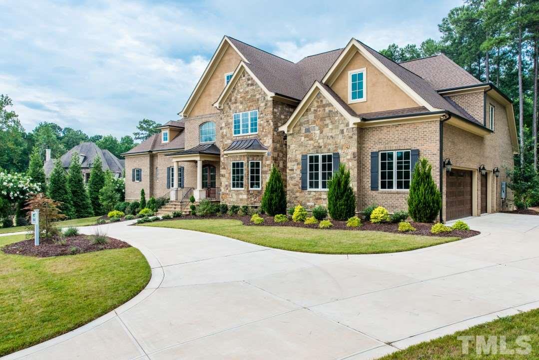 11005 Soco Gap Court Raleigh, NC 27613 - Photo 2 of 25 a front view of a house with a yard table and chairs