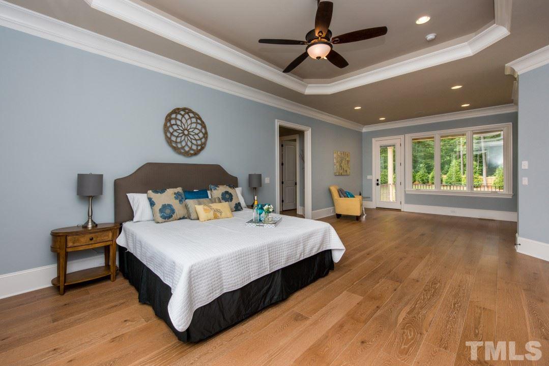 11005 Soco Gap Court Raleigh, NC 27613 - Photo 11 of 25 a bedroom with a bed and a large window