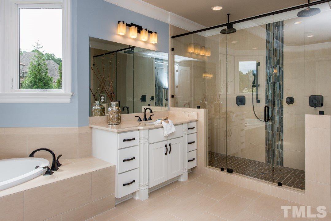 11005 Soco Gap Court Raleigh, NC 27613 - Photo 14 of 25 a bathroom with a double vanity sink mirror and shower