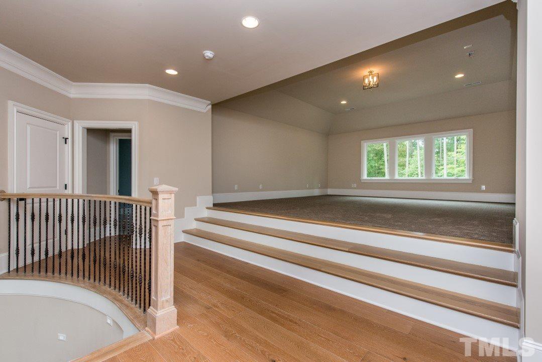 11005 Soco Gap Court Raleigh, NC 27613 - Photo 15 of 25 a view of empty room with stairs and a floor to ceiling window