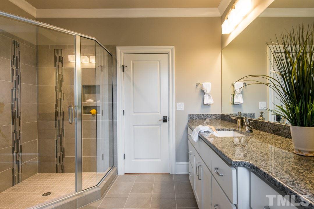 11005 Soco Gap Court Raleigh, NC 27613 - Photo 19 of 25 a bathroom with a granite countertop sink mirror and shower