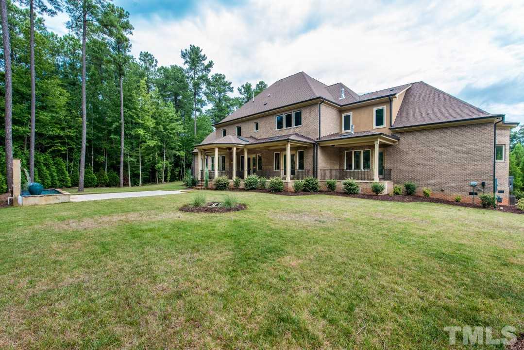 11005 Soco Gap Court Raleigh, NC 27613 - Photo 25 of 25 a front view of a house with a yard table and trees