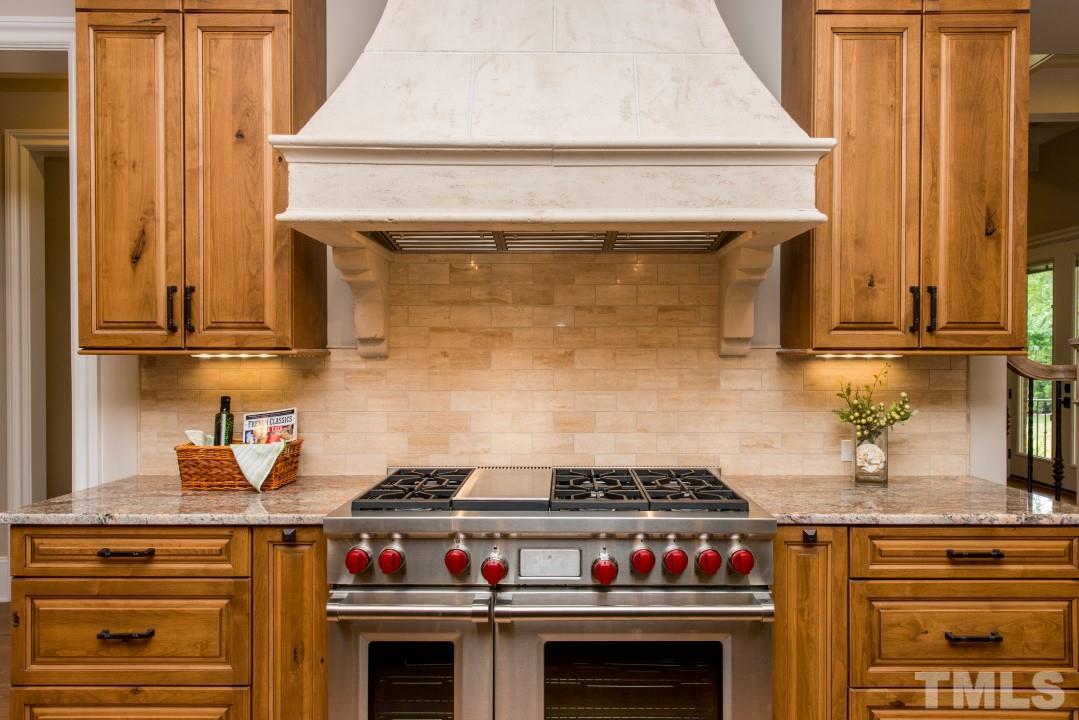 11005 Soco Gap Court Raleigh, NC 27613 - Photo 7 of 25 a stove top oven sitting inside of a kitchen