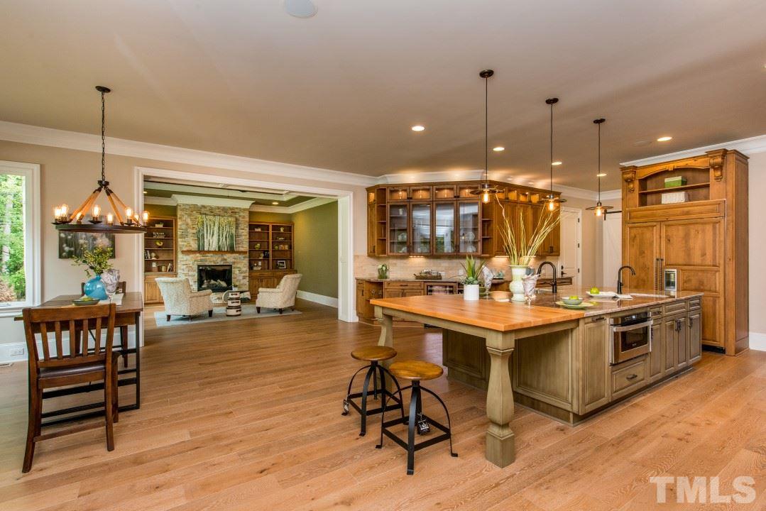 11005 Soco Gap Court Raleigh, NC 27613 - Photo 8 of 25 a view of a dining room and livingroom with furniture wooden floor a chandelier