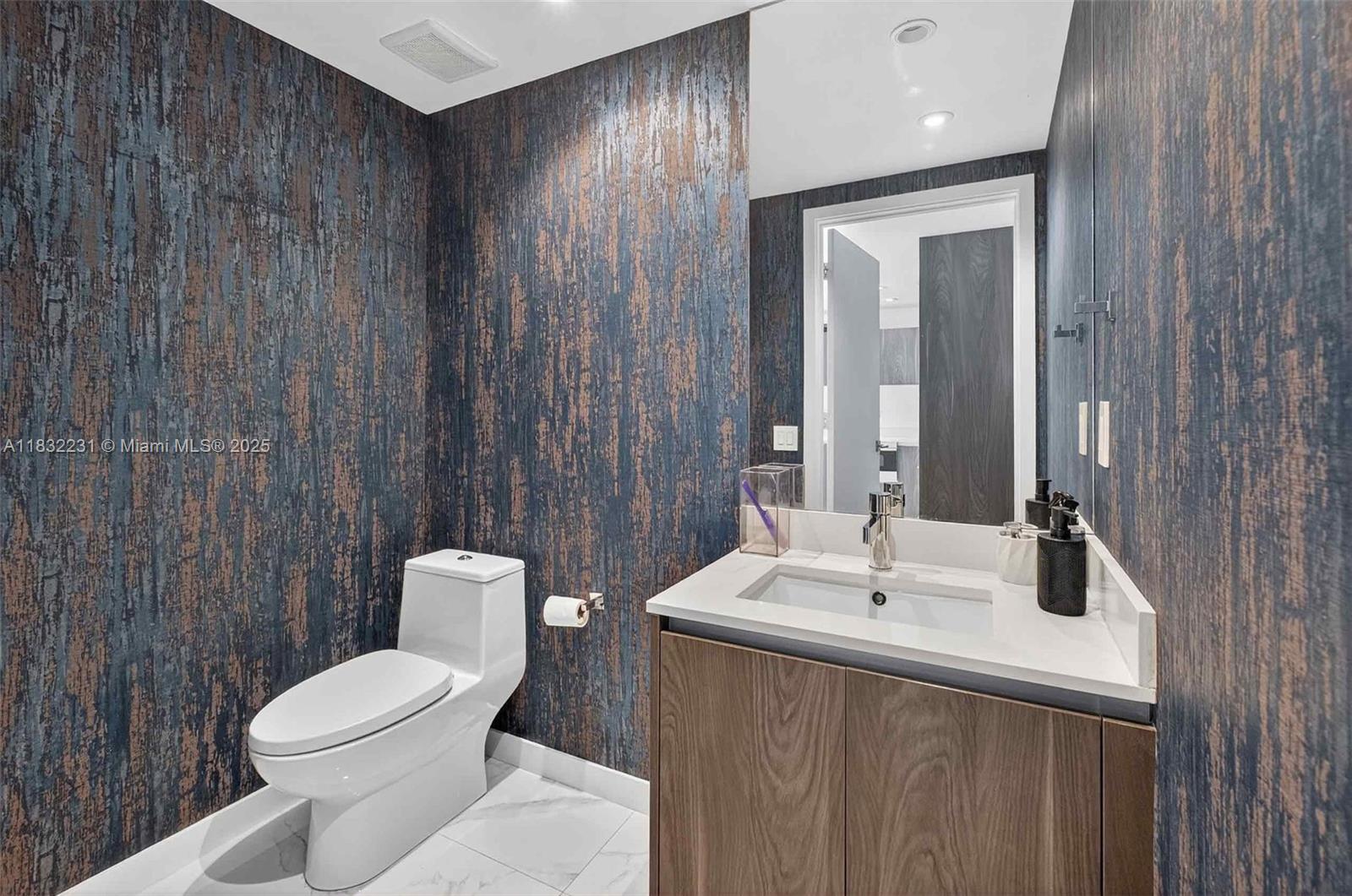 3131 Northeast 7th Avenue, Unit 4503 Miami, FL 33137 - Photo 11 of 51 a bathroom with a toilet a sink and mirror