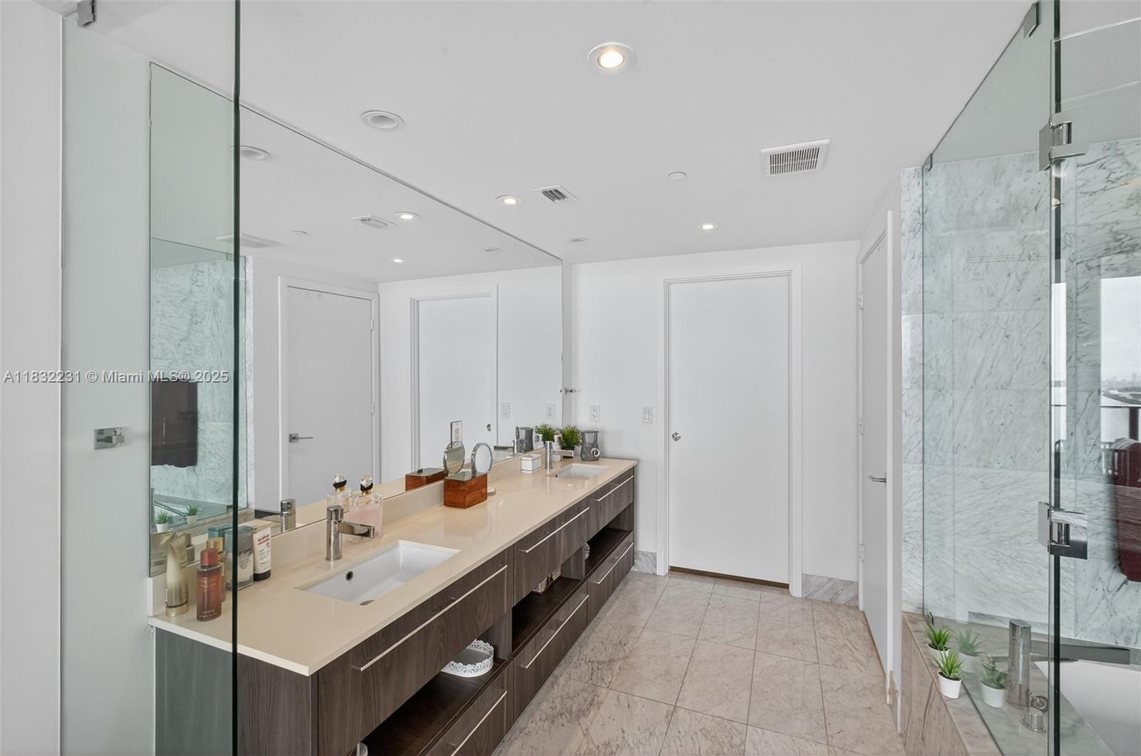3131 Northeast 7th Avenue, Unit 4503 Miami, FL 33137 - Photo 14 of 51 a bathroom with a double vanity sink mirror and shower