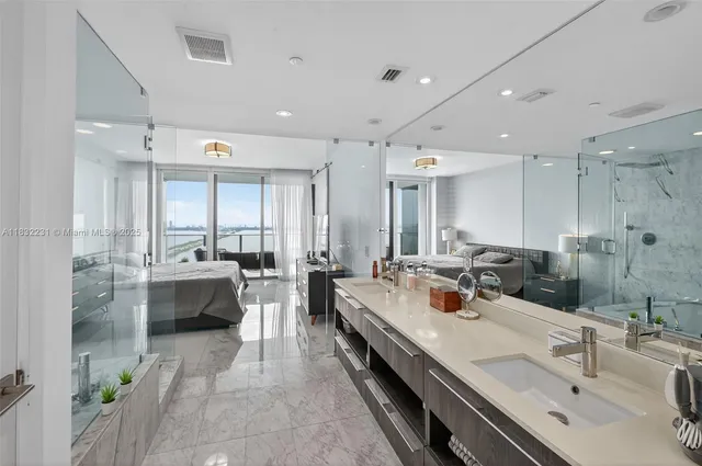 a large kitchen with a large counter top appliances and cabinets