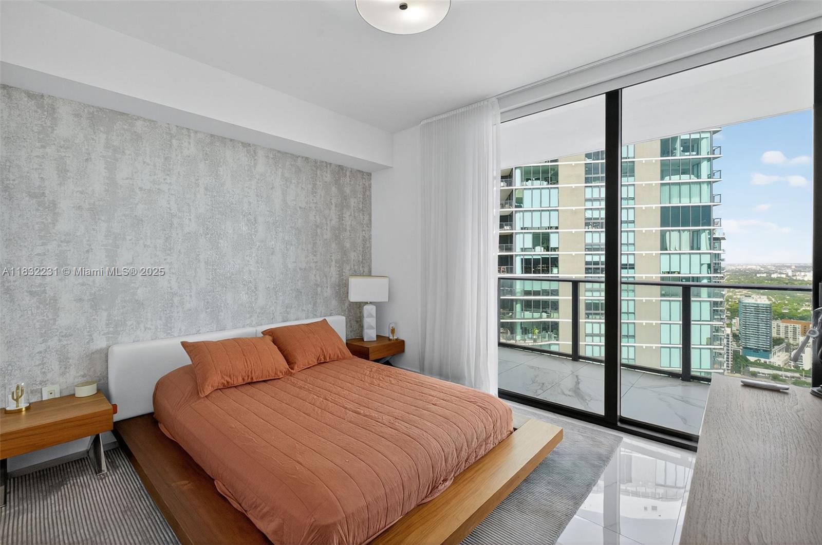 3131 Northeast 7th Avenue, Unit 4503 Miami, FL 33137 - Photo 29 of 51 a bedroom with a large bed and a window