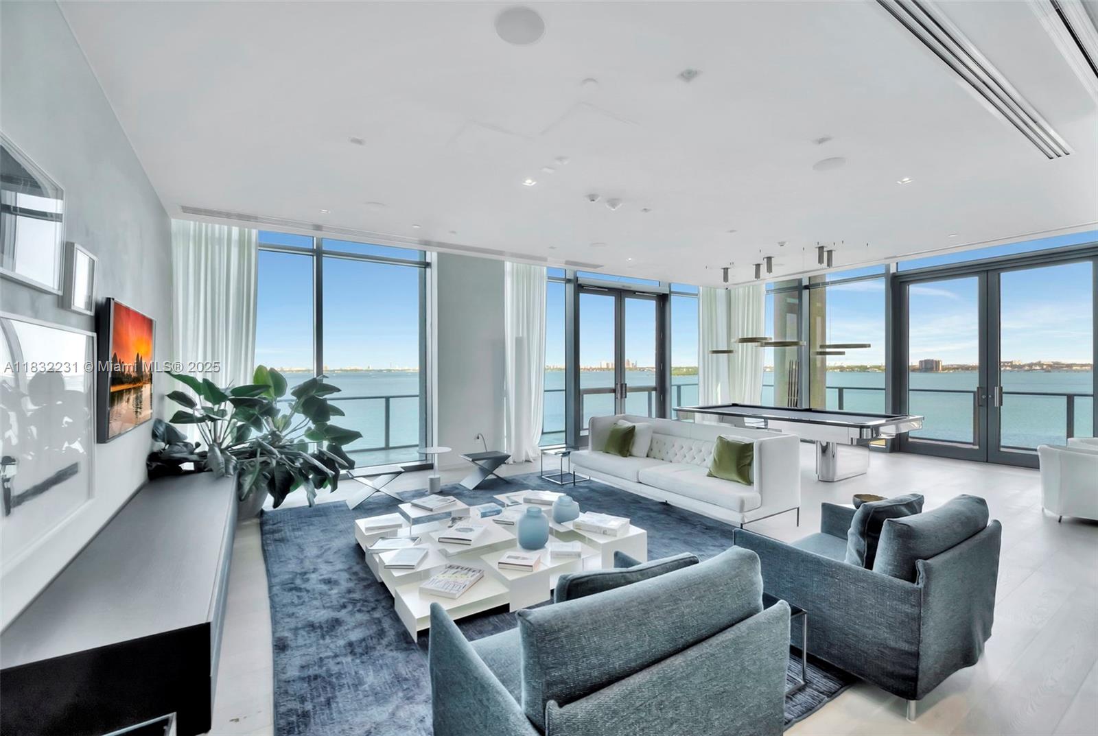 3131 Northeast 7th Avenue, Unit 4503 Miami, FL 33137 - Photo 47 of 51 a living room with furniture potted plant a flat screen tv and a large window
