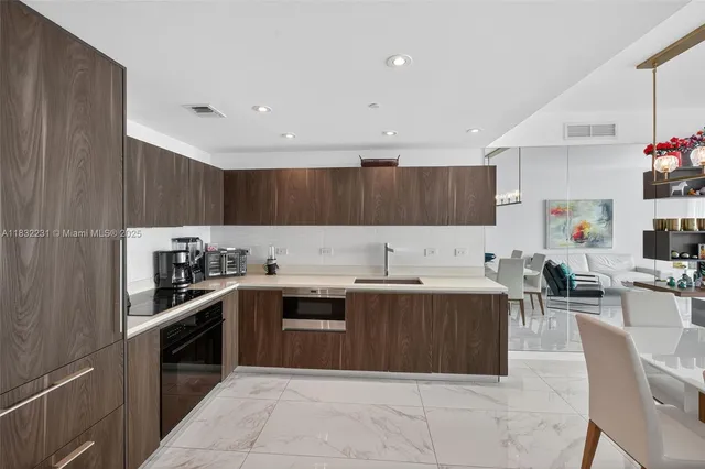 a kitchen with stainless steel appliances granite countertop a sink counter space cabinets and a counter top space