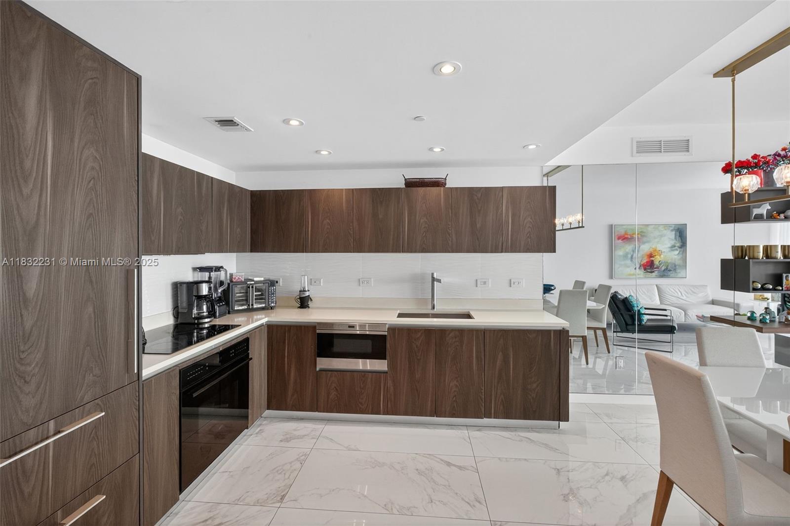3131 Northeast 7th Avenue, Unit 4503 Miami, FL 33137 - Photo 5 of 51 a kitchen with stainless steel appliances granite countertop a sink counter space cabinets and a counter top space