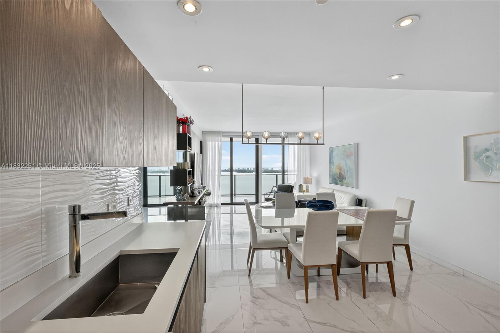 3131 Northeast 7th Avenue, Unit 4503 Miami, FL 33137 - Photo 6 of 51 a dining hall with couches a coffee table and chairs with wooden floor