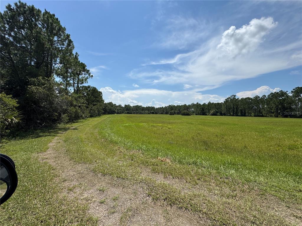 4300 Justa Road Mims, FL 32754 - Photo 23 of 61 a view of a lake with a big yard