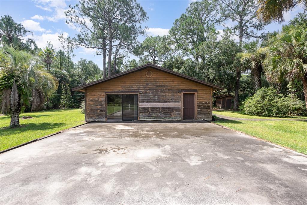 4300 Justa Road Mims, FL 32754 - Photo 28 of 61 a front view of a house with a yard and garage