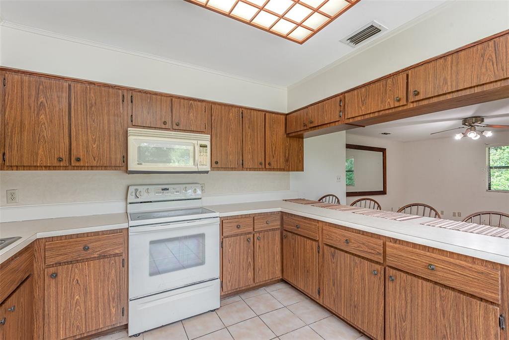 4300 Justa Road Mims, FL 32754 - Photo 37 of 61 a kitchen with sink a stove and cabinets