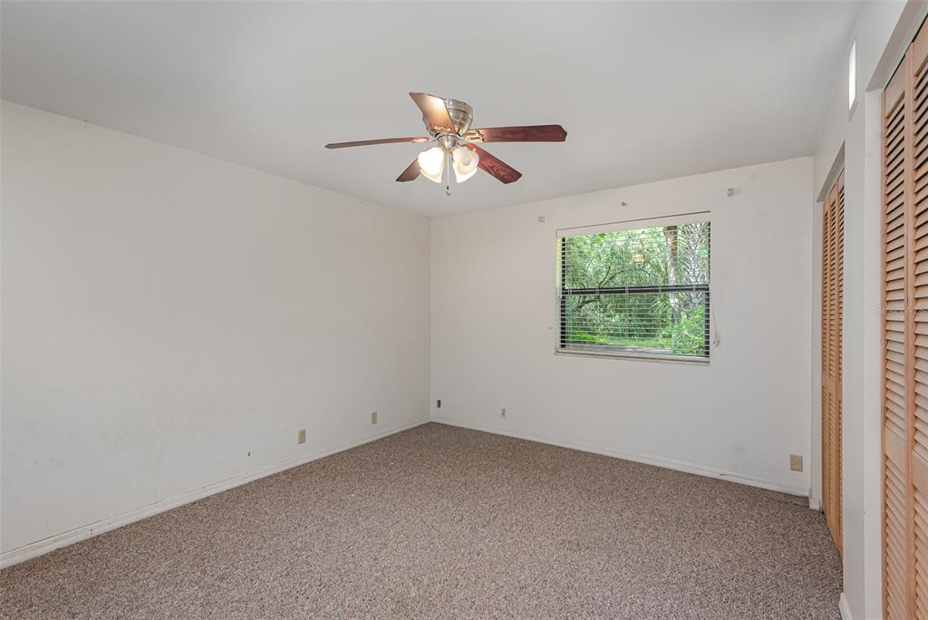 4300 Justa Road Mims, FL 32754 - Photo 38 of 61 an empty room with a window and a fan