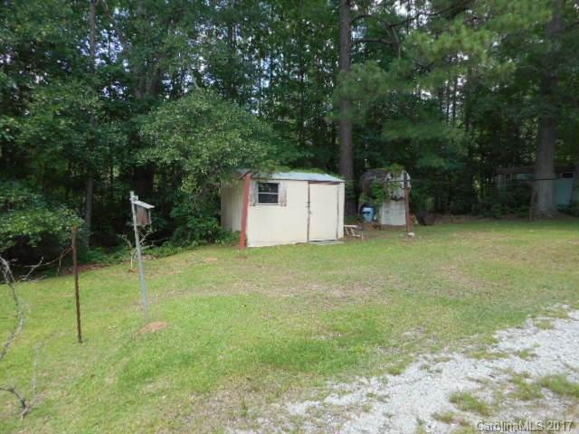 1007 Old Thompson Avenue Lancaster, SC 29720 - Photo 13 of 13 a backyard of a house with plants and large trees