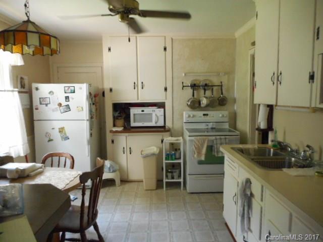 1007 Old Thompson Avenue Lancaster, SC 29720 - Photo 5 of 13 a kitchen with cabinets and stainless steel appliances