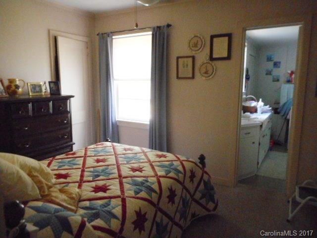 1007 Old Thompson Avenue Lancaster, SC 29720 - Photo 9 of 13 a bedroom with a bed and a mirror