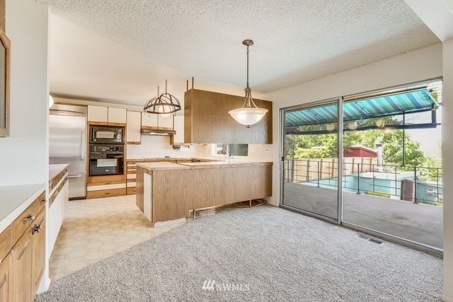 a kitchen with counter top space cabinets and outdoor view