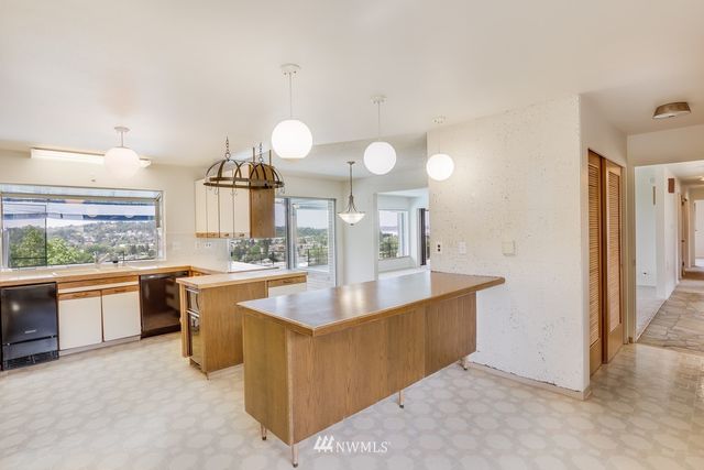 a kitchen with granite countertop a sink cabinets and window